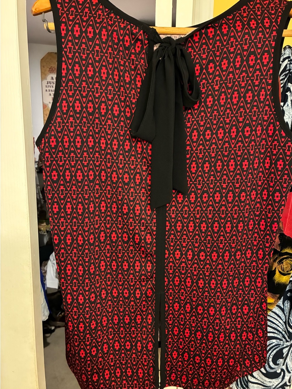 Faith and Joy Black/Red Sleeveless Top with Geometric Print. Businesswoman